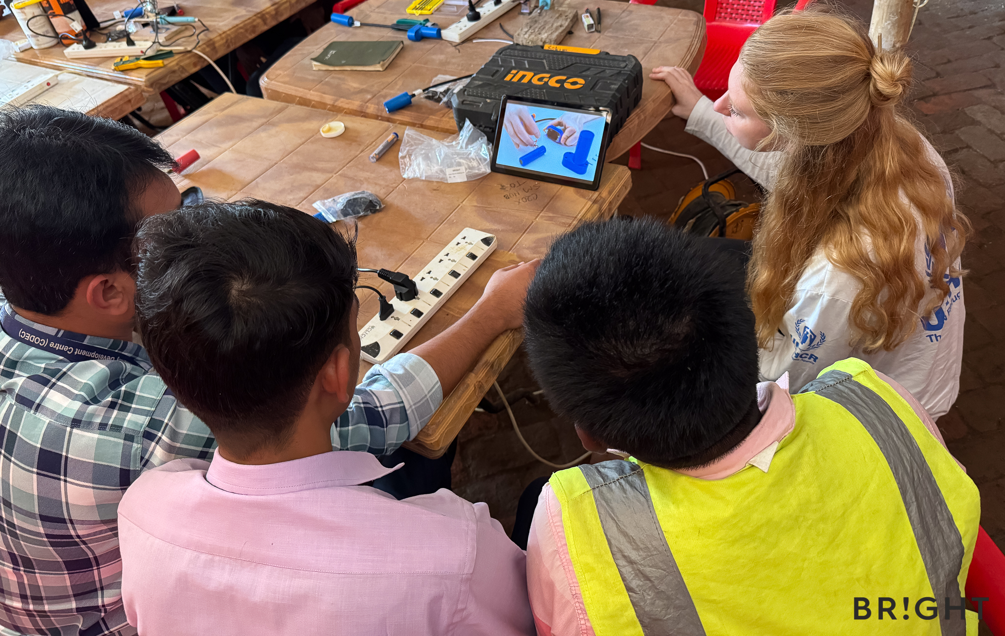 Trainees follow a video explaining how to replace SunBell batteries as part of BRIGHT’s repair programme.
